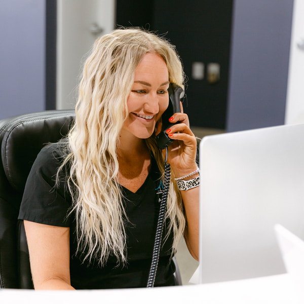 A woman is smiling at Amley McEntire front desk