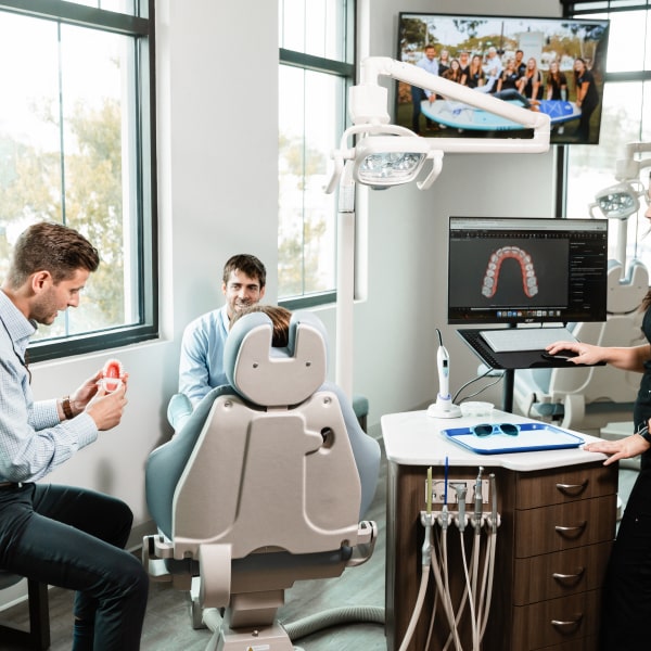 Get Expert Orthodontic Care for a Healthy, Confident Smile! Amley McEntire Orthodontics dentist and a patient are smiling