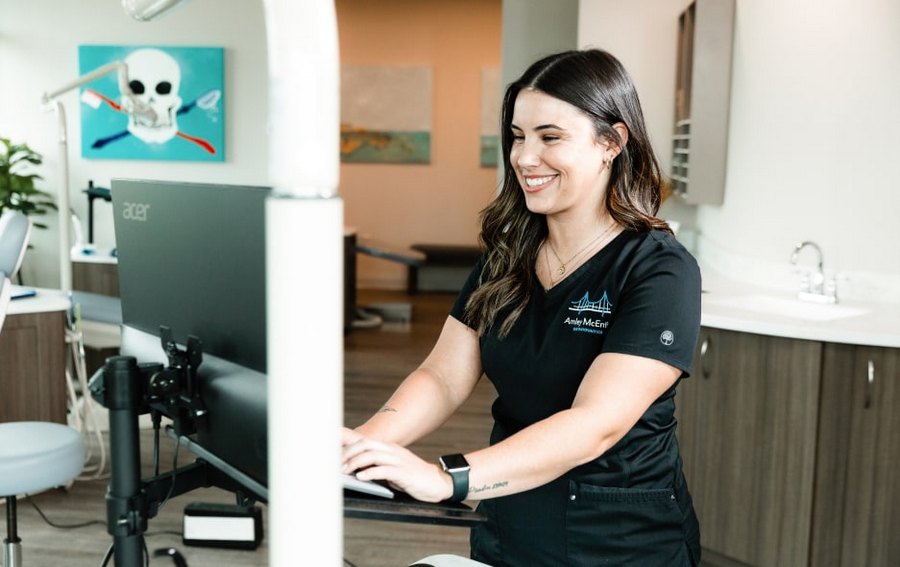 Book Your Virtual Consultation Today: Convenient Care from Home. Dental specialist is smiling at Amley McEntire