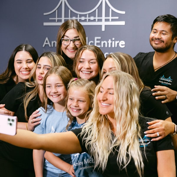 Trusted Orthodontic Care with a Personal Touch. Dental team and happy patients making selfie at Amley McEntire Orthodontics